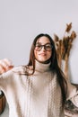 Authentic lifestyle portrait of attractive young caucasian woman in eyeglasses at home