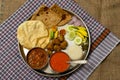 Authentic Maharashtrian lunch thali with Amras and poli, India.