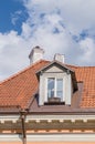Authentic mansard window in a old style tiled roof Royalty Free Stock Photo