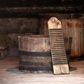 Authentic old laundry wringer washboard in a wooden half barrel tub