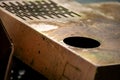 Authentic old style industrial background. Close-up of a dirty part of an old road roller. Orange colored metal Royalty Free Stock Photo