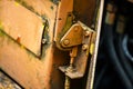 Authentic old style industrial background. Close-up of a dirty part of an old road roller. Orange colored metal Royalty Free Stock Photo