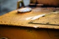 Authentic old style industrial background. Close-up of a dirty part of an old road roller. Orange colored metal Royalty Free Stock Photo