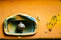 Authentic old style industrial background. Close-up of a dirty part of an old road roller. Orange colored metal Royalty Free Stock Photo