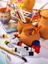 Authentic paint brushes still life on table in art class school. Royalty Free Stock Photo