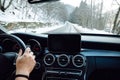 Authentic portrait of driver on mountain curvy roads. Driver hands and point of view