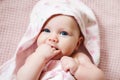 Authentic portrait of 4 months baby girl wrapped in towel after bath. Royalty Free Stock Photo