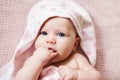 Authentic portrait of 4 months baby girl wrapped in pink towel after bath. Royalty Free Stock Photo