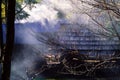 Authentic rural house in smoke against background of wild nature. Carpathian Mountains, Ukraine, copy space,