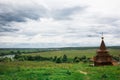 Authentic Russian wooden Church building on a high hill with panoramic views. Royalty Free Stock Photo