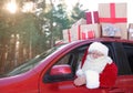 Authentic Santa Claus driving car with gift boxes Royalty Free Stock Photo