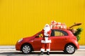 Authentic Santa Claus near red car with gift boxes Royalty Free Stock Photo