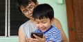 Authentic son and father looking on smartphone outdoor with happy smiling face. Royalty Free Stock Photo