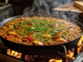 Authentic spanish paella made in the traditional spanish paella pan, over the fire