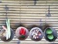 Authentic Thai red curry ingredients in coconut shells on bamboo table