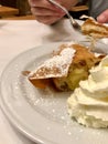 Authentic Traditional Apple Strudel, Apfelstrudel in Vienna, Austria. Served on a white plate, in restaurant setting. Vanilla ice Royalty Free Stock Photo