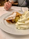 Authentic Traditional Apple Strudel, Apfelstrudel in Vienna, Austria. Served on a white plate, in restaurant setting. Vanilla ice Royalty Free Stock Photo