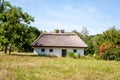 Authentic Ukrainian house in countryside. Summer village in Ukraine. Old folk thatched house. Ukrainian traditional rustic house. Royalty Free Stock Photo