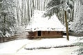 Authentic ukrainian village with wooden huts and fences in winter.