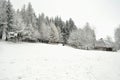 Authentic ukrainian village with wooden huts and fences in winter.