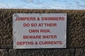 Isolated sign warning of danger of water depth and currents