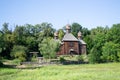 Authentic wooden Slavic Orthodox church against the sky and trees