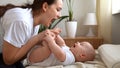 Authentic Young Caucasian Woman Holding Newborn Baby. Mom And Child On Bed. Close-up Portrait of Smiling Family With Royalty Free Stock Photo