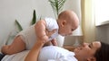 Authentic Young Caucasian Woman Holding Newborn Baby. Mom And Child On Bed. Close-up Portrait of Smiling Family With Royalty Free Stock Photo