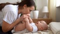 Authentic Young Caucasian Woman Holding Newborn Baby. Mom And Child On Bed. Close-up Portrait of Smiling Family With Royalty Free Stock Photo