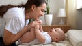 Authentic Young Caucasian Woman Holding Newborn Baby. Mom And Child On Bed. Close-up Portrait of Smiling Family With Royalty Free Stock Photo