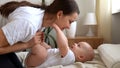 Authentic Young Caucasian Woman Holding Newborn Baby. Mom And Child On Bed. Close-up Portrait of Smiling Family With Royalty Free Stock Photo