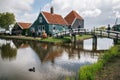 Authentic Zaandam mills and traditional vibrant houses on the water canal in Zaanstad village, Netherlands