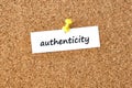 Authenticity. Word written on a piece of paper, cork board background