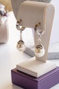 author beautiful pearl earrings demonstrated around white backround. fashion and jewelry concept
