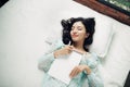 Author, Typewriter, Journalist. Intelligent woman lying on bed a Royalty Free Stock Photo