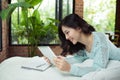 Author, Typewriter, Journalist. Intelligent woman lying on bed a Royalty Free Stock Photo