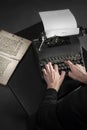 Old typewriter and an ancient manuscript