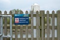 Authorised personnel sign seen attached to a wooden fence at a boatyard.