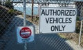 Authorized vehicles only sign on steel fence