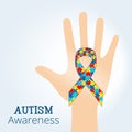 Autism awareness concept with hand holding ribbon of puzzle pieces Royalty Free Stock Photo