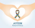 Autism awareness concept with hand holding ribbon of puzzle pieces Royalty Free Stock Photo