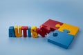 Autism awareness concept with puzzle and word autism on blue background. Royalty Free Stock Photo