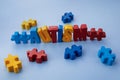 Autism awareness concept with puzzle and word autism on blue background. Royalty Free Stock Photo