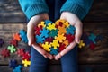 Autism awareness day concept. childs hands holding puzzle heart, support for autism spectrum Royalty Free Stock Photo