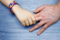 Autism Awareness Picture. Father holding hand her Autistic Child