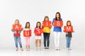 Autism. Group of children with red banners isolated in white Royalty Free Stock Photo