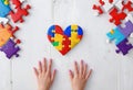 Autism. Making heart of color puzzle pieces Royalty Free Stock Photo