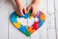 Autism. Making heart of color puzzle pieces Royalty Free Stock Photo