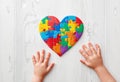 Autism. Making heart of color puzzle pieces Royalty Free Stock Photo