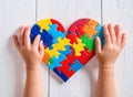 Autism. Making heart of color puzzle pieces Royalty Free Stock Photo